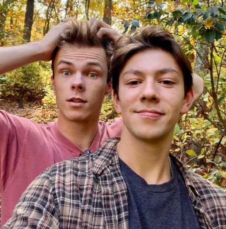 Nicholas Hamilton and his partner, Jackson, in the woods.